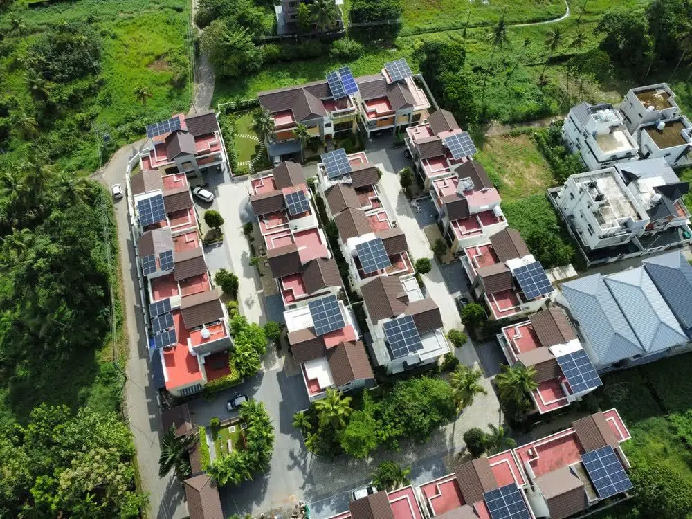 Aerial view of a villa community with rooftop solar across the development