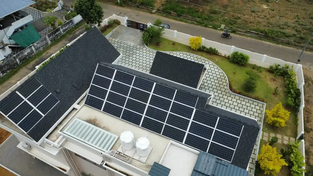 Rooftop solar array on a residential villa with a shingled roof